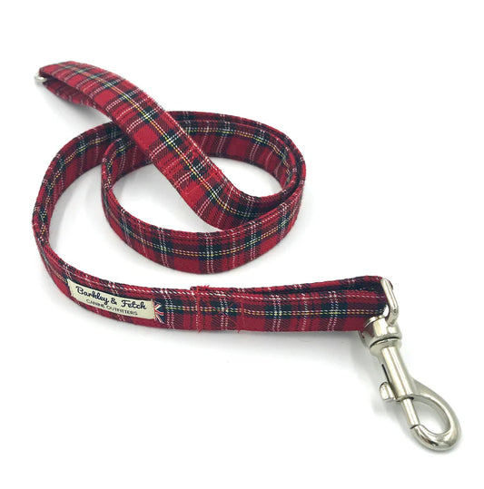 A red Stewart tartan dog lead with a comfortable loop handle, an accessory attachment ring, and a strong steel trigger clip.