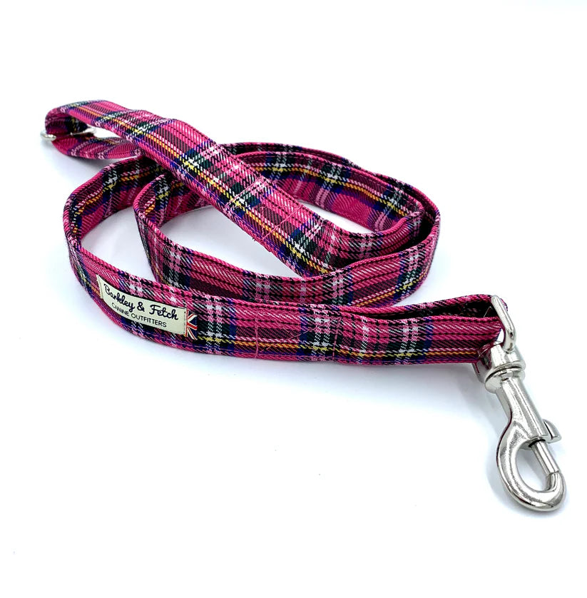 A bright pink tartan pattern dog lead with a comfortable loop handle, an accessory attachment ring, and a strong steel trigger clip.