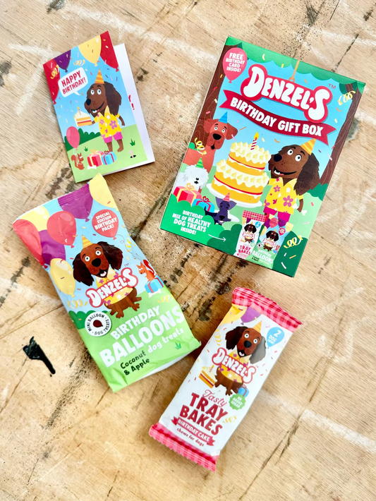 Four Denzel's birthday-themed packages on a wooden surface